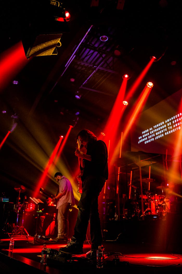 Dynamic live band performance with striking red lighting effects on stage.